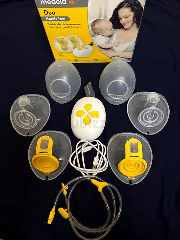 Medela Portable electric breast pump set with 4 flanges and tubing (used)brand new condition