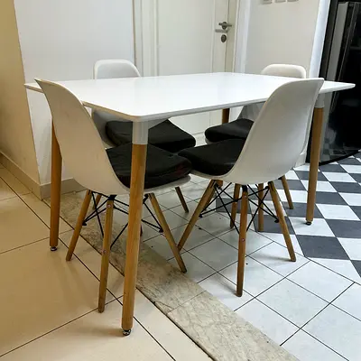 Modern White Dining Table with 4 Eames‑Style Chairs