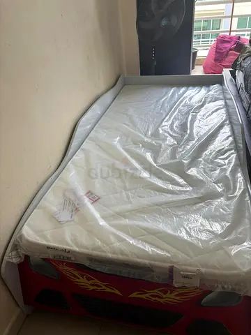 Red car-shaped kids bed with mattress - used, good condition