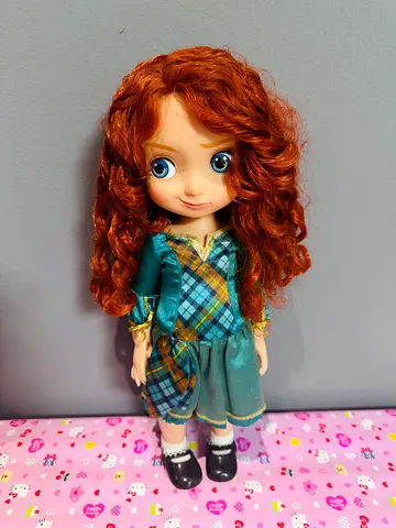 Disney Merida  collectible doll in green tartan dress — good condition