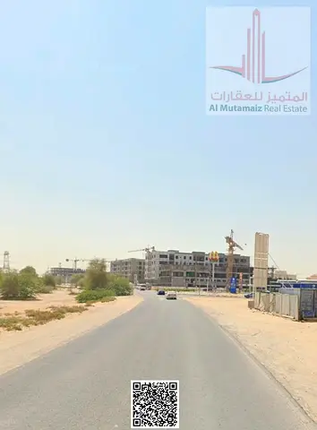 أرضين سكني تجاري للبيع في المويهات 3 عجمان على الشارع الرئيسي تصريح أرضي + 4 مساحة كبيرة