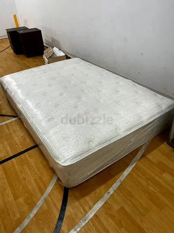 Double size mattress wrapped in protective plastic - good condition