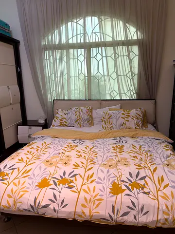 Queen bed 1 beside table