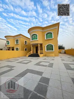 Villa for sale in Ajman, Al Muwaihat area. 5 master bedrooms, majlis, 2 living rooms, and a maid'