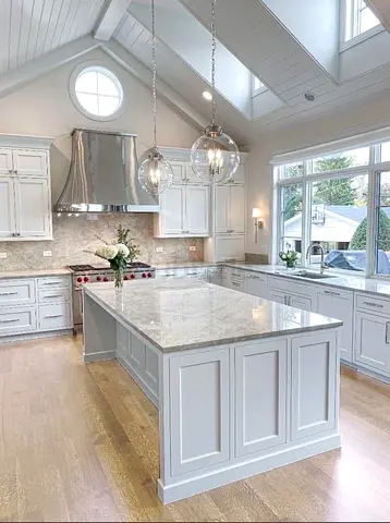 Spacious White Kitchen Island with Marble Top and Custom Cabinetry