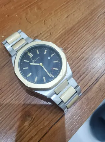 gold and silver color watch needs battery swap and needs watch hand repair
