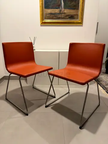 Set of 2 Bernhard IKEA leather chairs in orange with metal legs. Excellent condition