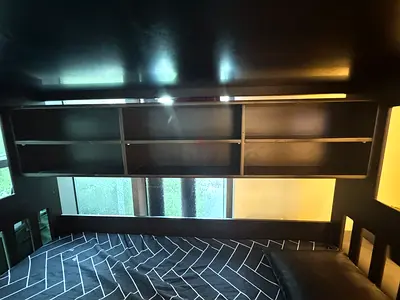 Dark wood loft bed with triple bed space and headboard storage