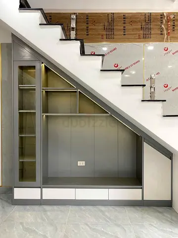 Custom-built under-stair storage unit with display cabinet and drawers