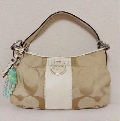 Coach Signature Stripe Demi bag in beige canvas.
