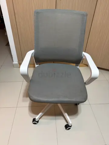 Compact grey office chair with casters — good condition