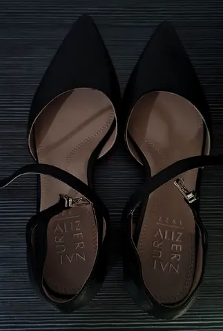 Black pointed-toe ankle-strap flats, size unknown