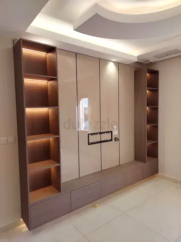 Custom wall-mounted entertainment unit with display shelves and storage