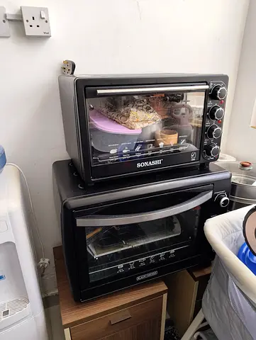 Two countertop electric ovens (Sonashi + Black  Decker) - used AED200 each