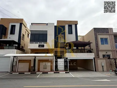 Two-story villa with a rooftop terrace, including electricity, water, and air conditioning, in one of Ajman's most prestigious areas. Freehold ownersh