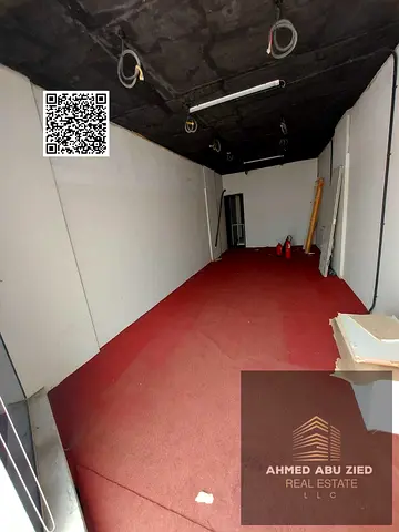 A spacious shop in Al Rawda 2 with a large mezzanine, near Al Hamidiya Police Station.