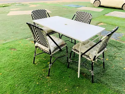 Outdoor 4-Seater Dining Set with Cushioned Rattan Chairs and Folding Table