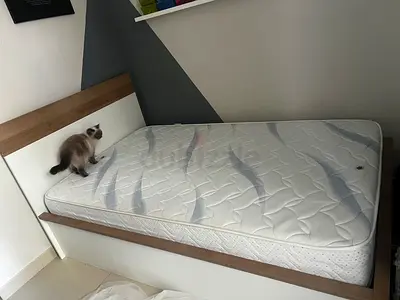 Bed with mattress and storage space under
