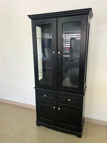 Storage cabinet with glass shelves, drawers, and wooden base cabinets.