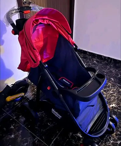 New baby stroller - new , condition (red canopy)