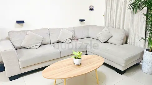 Light Grey L-Shaped Fabric Sofa with Wooden Coffee Table