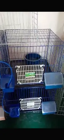 Two-level metal bird cage with feeders and perches - good condition