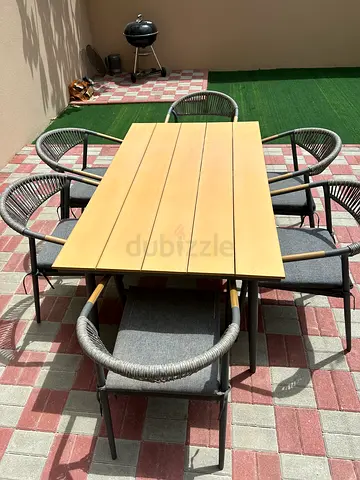Outdoor dining table with 6 rattan-style chairs