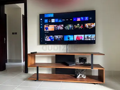 65-inch Smart LED TV mounted with wooden TV stand