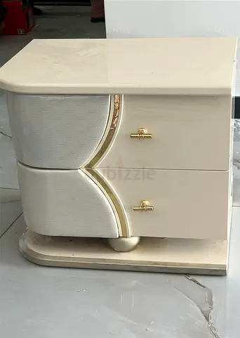Cream lacquered bedside table with two drawers and gold handles