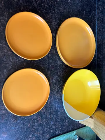 Set of 3 mustard yellow ceramic dinner plates and 1 plastic salad bowl
