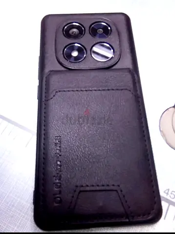 Pre-owned smartphone with leather case (camera module visible)