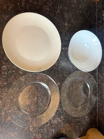 Set of white ceramic bowl and clear glass dinner plates