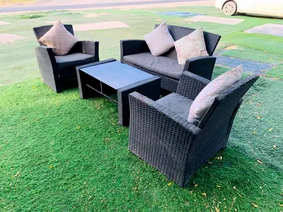 4-piece Outdoor Rattan Sofa Set with Coffee Table and Cushions