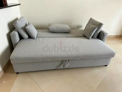 Light grey three-seater sofa bed with storage — good condition