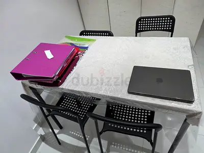 IKEA dining table with 4 black perforated chairs - used