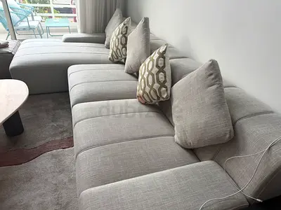 Light beige Modular Fabric Sofa 3 seater with 3 beige pillows and two green pillows. Good Condition