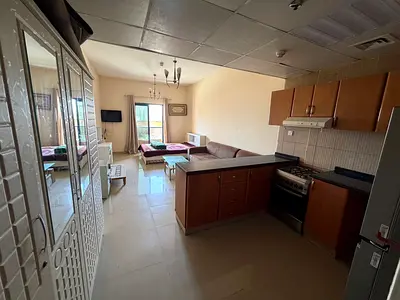 Furnished studio apartment in Tower C, Al Nuaimiya 1, Ajman. Free parking, balcony, and free maintenance.