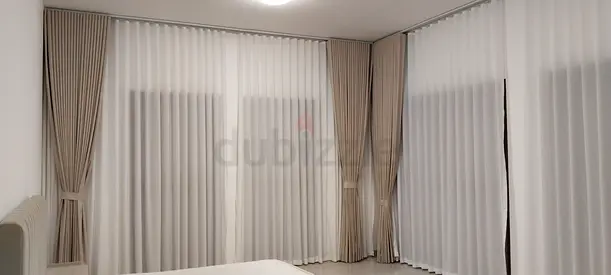 Full-length neutral beige fabric curtains with sheer liners - set for corner windows