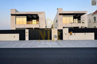 Luxury villa in Al Muwaihat 2, modern design with a yard, outdoor seating area, and central air conditioning. Freehold ownership.