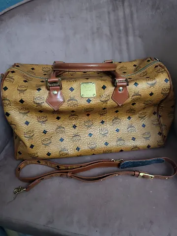 Vintage-style tan monogram travel duffel bag with detachable shoulder strap
