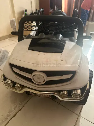 White electric ride-on toy car for kids (needs battery replacement)