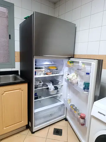 Used single-door top-freezer refrigerator in stainless steel finish