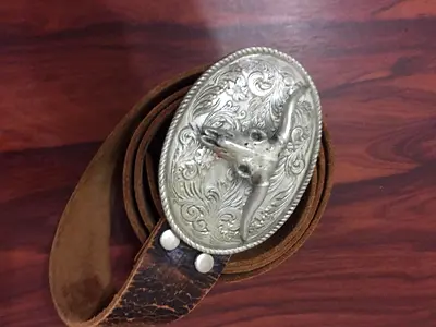 Vintage brown leather belt with decorative silver steer buckle