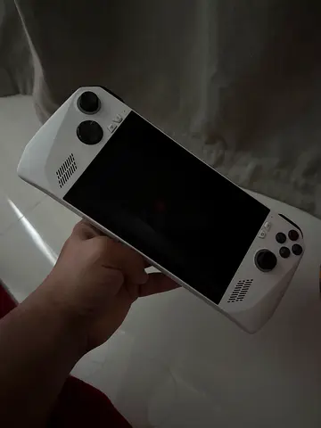 White handheld Android/PC gaming console with dual analog sticks (used)