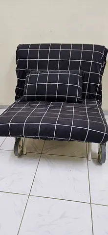 Single black checkered lounge chair with cushion - good condition
