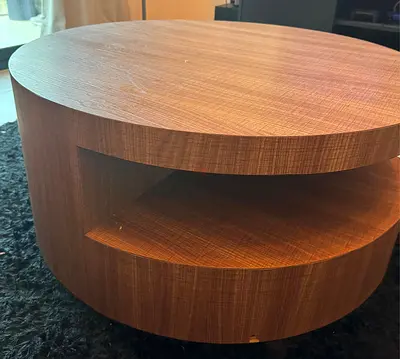 Round wooden coffee table with hidden shelf - good condition