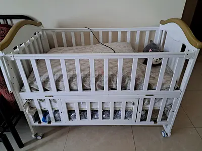 White Wooden Baby Crib with Wheels and Storage