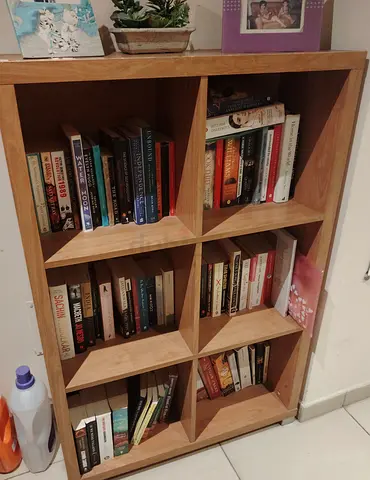 Small wooden bookshelf with mixed paperback books (collection)