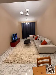 Luxury one-bedroom apartment with a living room and balcony offering an open view. Ajman, Al Rashidi