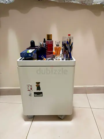 Small white bedside cabinet on wheels - compact storage unit